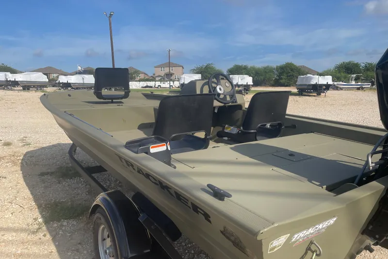 Slide: The Image of 2026 Tracker Grizzly 1754 SC boat on trailer, parked outdoors under clear sky. - 3