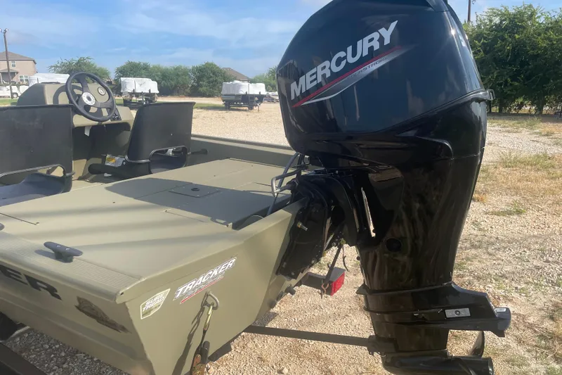 Slide: The Image of 2026 Tracker Grizzly 1754 SC boat with Mercury outboard motor in outdoor setting. - 4