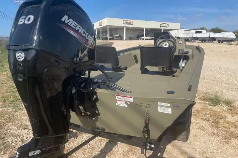 Slide: The Image of 2026 Tracker Grizzly 1754 SC boat with Mercury 60 engine, parked outdoors. - 5