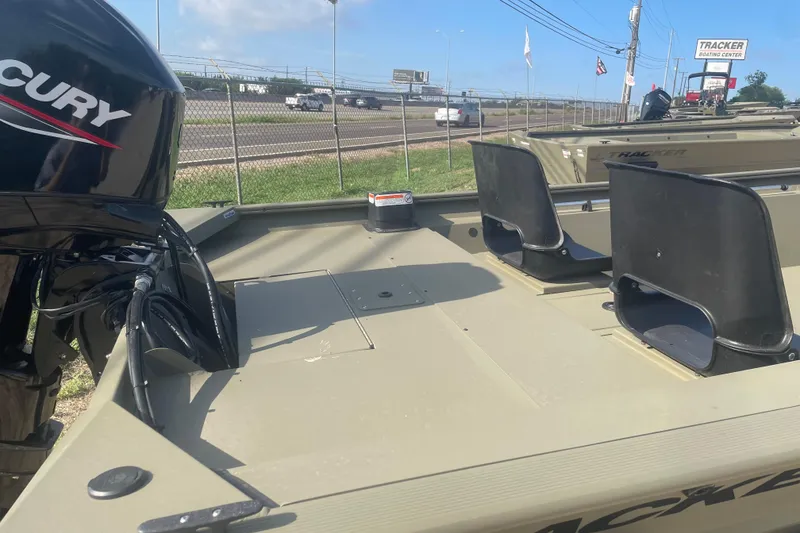 Slide: The Image of 2026 Tracker Grizzly 1754 SC boat with Mercury engine, displayed at a boating center. - 6