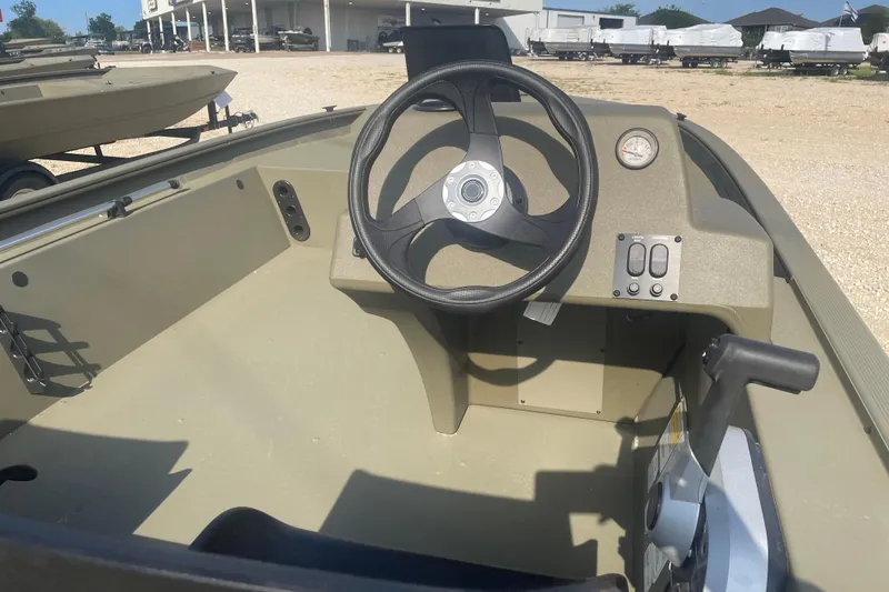 Slide: The Image of 2026 Tracker Grizzly 1754 SC boat interior with steering wheel and control panel. - 8