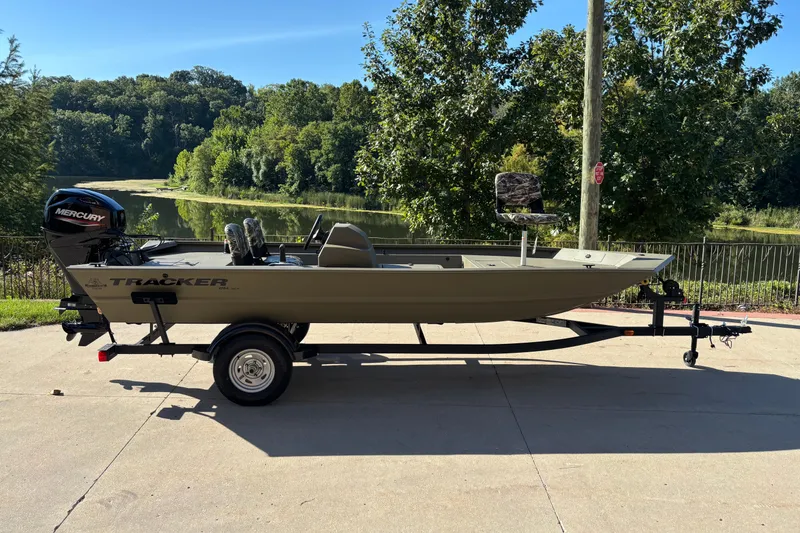 The Image of 2026 Tracker Grizzly 1754 SC boat on trailer, parked near scenic lake. - 0
