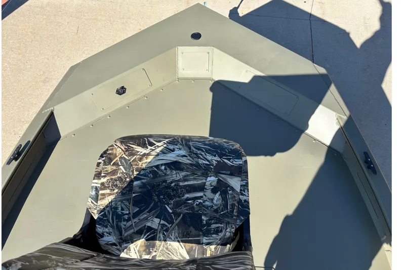 Slide: The Image of 2026 Tracker Grizzly 1754 SC boat interior with camouflage seat and spacious deck. - 3