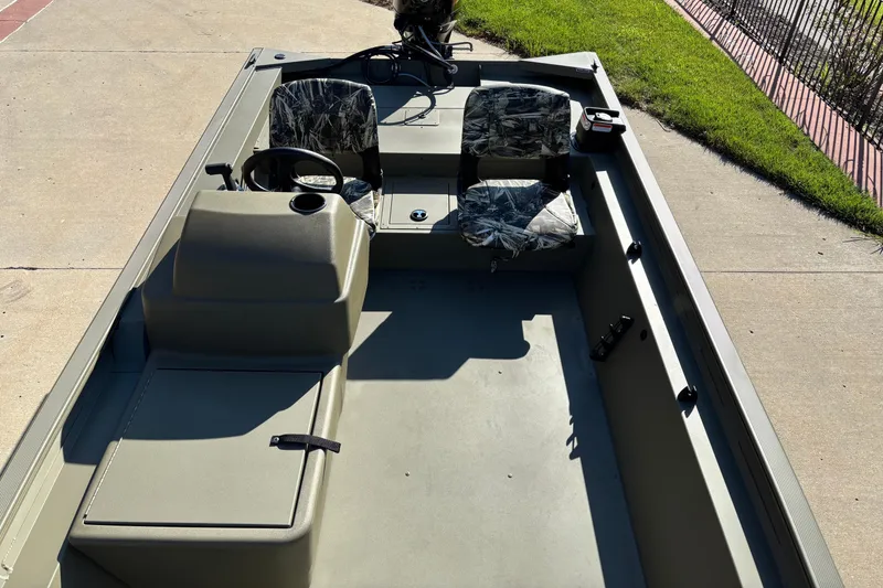 Slide: The Image of 2026 Tracker Grizzly 1754 SC boat with camo seats, steering console, and spacious interior. - 4