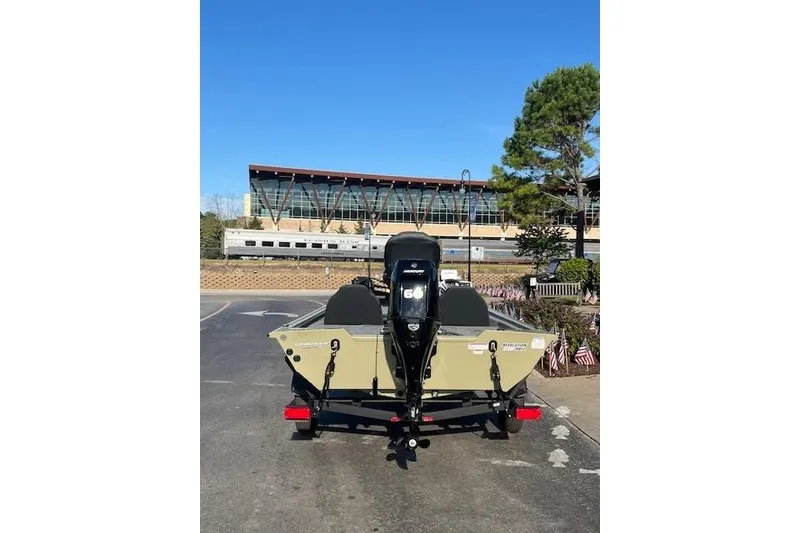 Slide: The Image of 2026 Tracker Pro Team 175 boat on trailer outside outdoor store, decorated for holiday. - 4