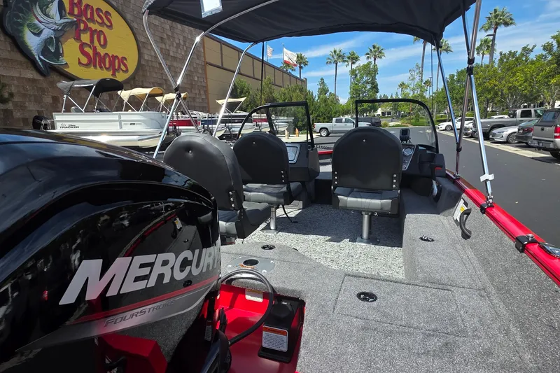 Slide: The Image of 2026 Tracker Pro Guide V-16 WT boat at Bass Pro Shops with Mercury engine. - 2
