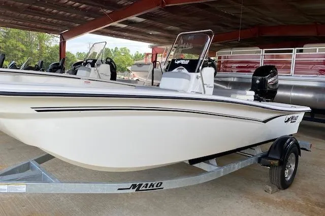 The Image of 2026 Mako Pro Skiff 15 CC boat on trailer under shelter. - 0