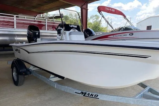 Slide: The Image of 2026 Mako Pro Skiff 15 CC boat on trailer, under a covered area. - 1