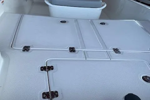 Slide: The Image of 2026 Mako Pro Skiff 15 CC boat deck with storage compartments. - 2