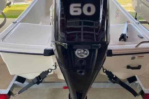 Slide: The Image of 2026 Mako Pro Skiff 15 CC with 60 HP outboard motor, rear view. - 4