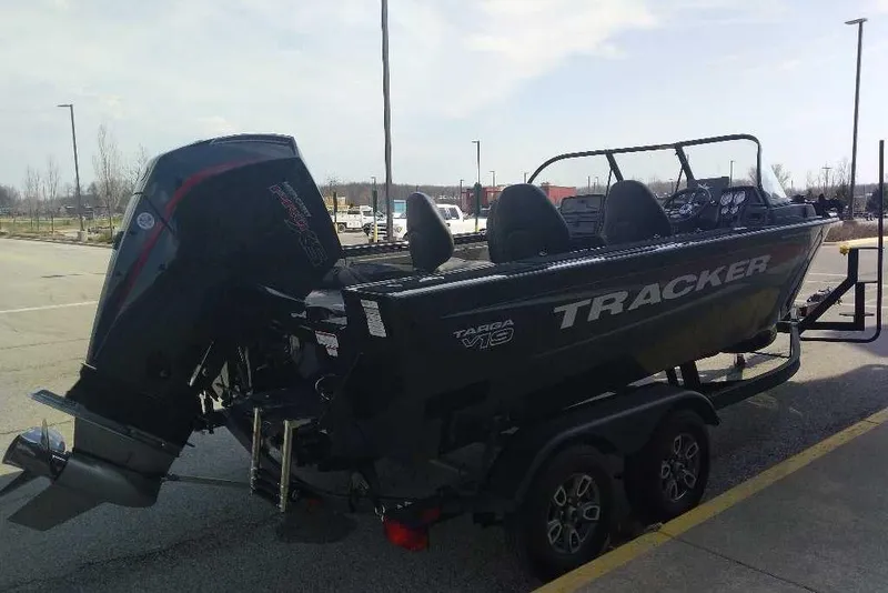 Slide: The Image of 2026 Tracker Targa V-19 WT boat on trailer, parked in a lot, side view. - 90