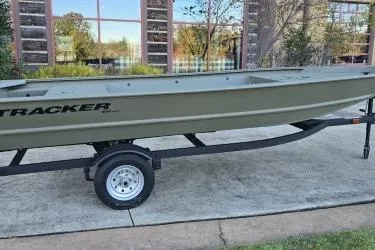 Slide: The Image of 2026 Tracker Grizzly 1648 Utility boat on trailer, parked outdoors. - 5