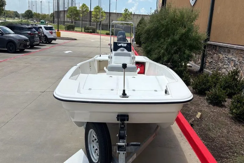 Slide: The Image of 2026 Mako Pro Skiff 17 CC boat on trailer in parking lot. - 1