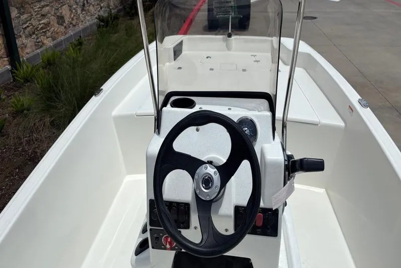 Slide: The Image of 2026 Mako Pro Skiff 17 CC boat interior with steering wheel and console. - 5