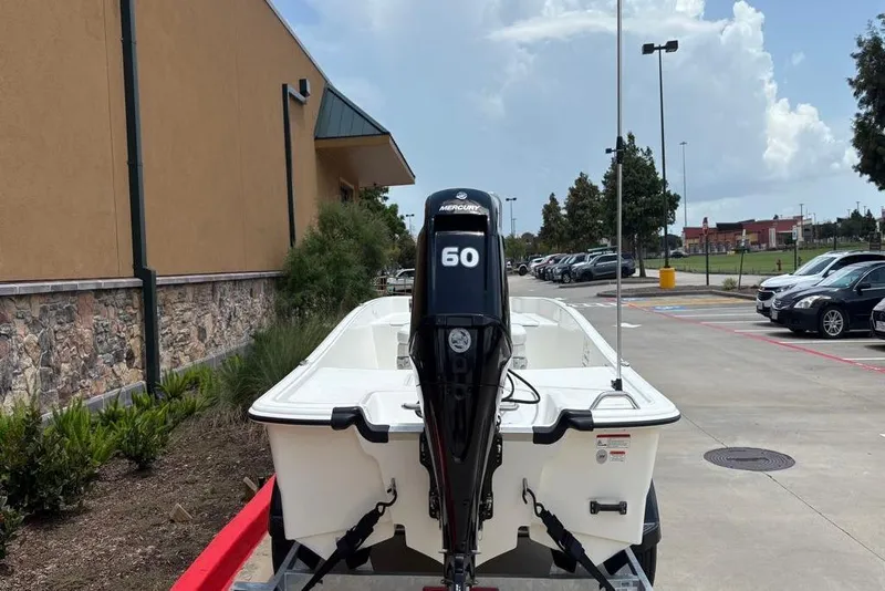 Slide: The Image of 2026 Mako Pro Skiff 17 CC boat with Mercury 60 engine in parking lot. - 6