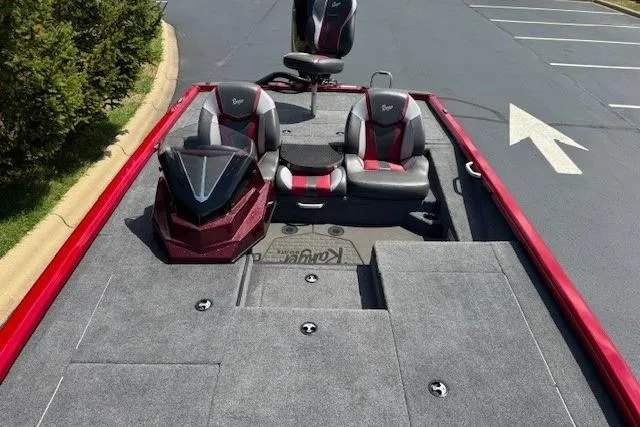 Slide: The Image of 2025 Ranger ALPHA 208 boat interior with red and gray seating, parked on asphalt. - 4