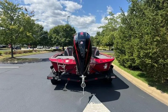 Slide: The Image of Red 2025 Ranger ALPHA 208 boat on trailer, parked outdoors under a sunny sky. - 5
