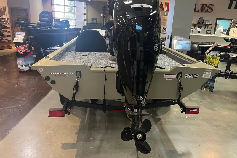 Slide: The Image of 2026 Tracker Pro Team 175 boat displayed indoors, rear view with motor. - 4