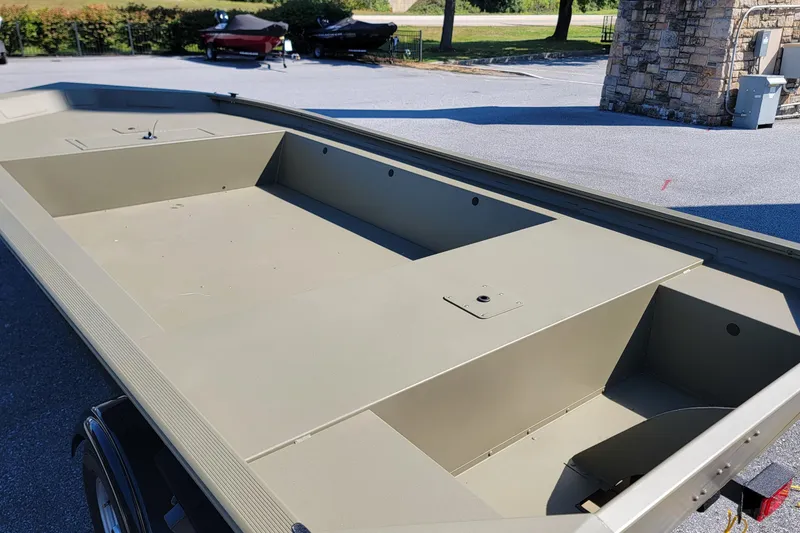 Slide: The Image of 2026 Tracker Grizzly 1754 Utility boat interior, showcasing spacious, durable design in outdoor setting. - 2