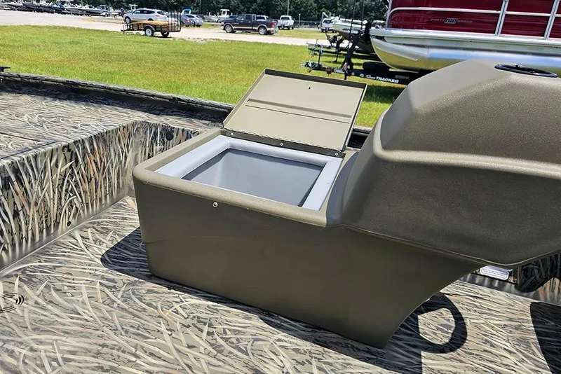 Slide: The Image of 2026 Tracker Grizzly 1754 SC boat with open storage compartment, camo design, and outdoor setting. - 13