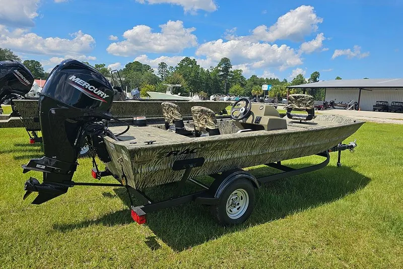 Slide: The Image of 2026 Tracker Grizzly 1754 SC boat with Mercury engine on grassy field. - 3
