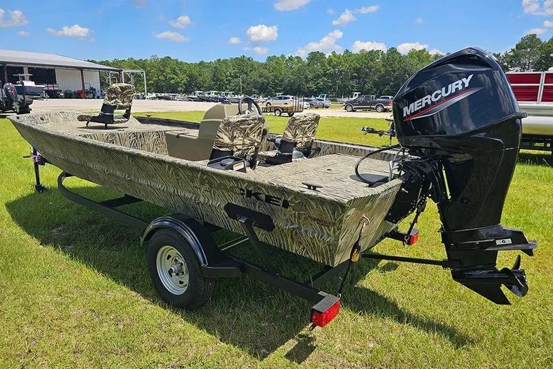 Slide: The Image of 2026 Tracker Grizzly 1754 SC boat with Mercury engine on trailer, parked on grass. - 7