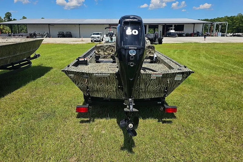 Slide: The Image of 2026 Tracker Grizzly 1754 SC boat with Mercury engine on grassy field. - 8