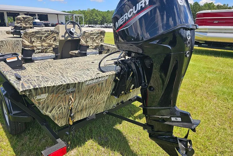 Slide: The Image of 2026 Tracker Grizzly 1754 SC boat with camo design and Mercury outboard motor. - 9