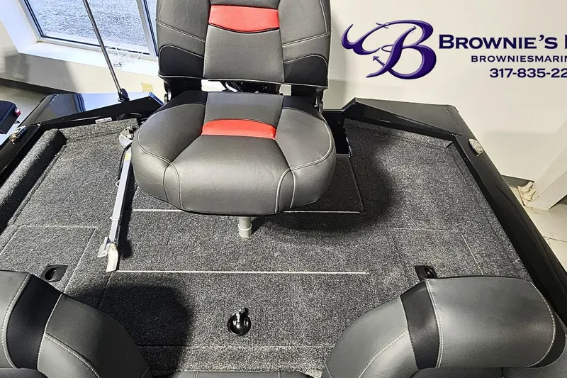 Slide: The Image of 2026 Tracker Pro Team 190 boat interior with seating and carpeted deck. - 13