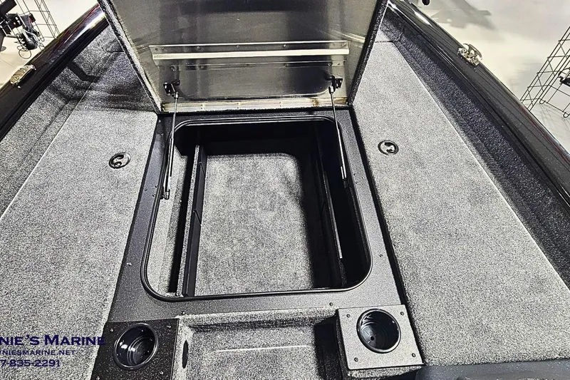 Slide: The Image of 2026 Tracker Pro Team 190 boat storage compartment with open lid, showcasing interior space. - 7