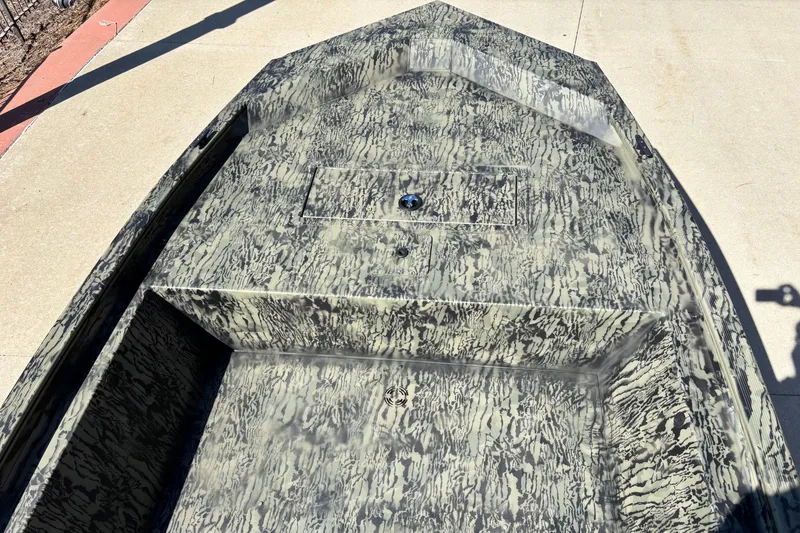 Slide: The Image of 2026 Tracker Grizzly 1648 Utility boat with camouflage pattern on concrete surface. - 3