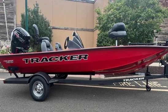 The Image of 2026 Tracker Pro Team 190 boat in vibrant red on a trailer, parked outdoors. - 0