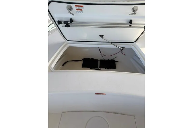 Slide: The Image of Open storage compartment of 2026 Mako 18 Pro Skiff boat, showcasing interior space. - 11