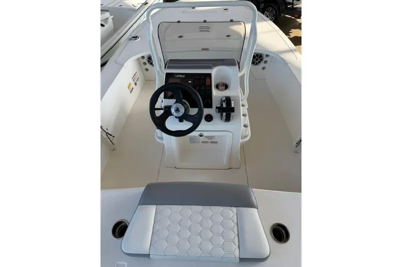 Slide: The Image of 2026 Mako 18 Pro Skiff boat interior with steering wheel and control panel. - 10