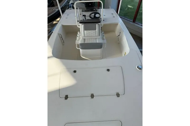 Slide: The Image of 2026 Mako 18 Pro Skiff boat interior with steering console and seating. - 7