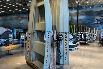 The Image of 2026 Tracker Grizzly 12 Jon boats displayed vertically in a showroom. - 0