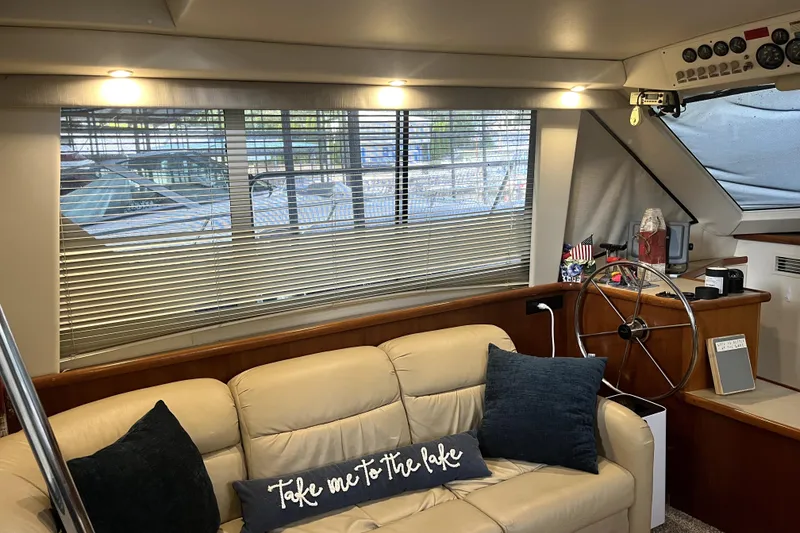 Slide: The Image of Interior of 1998 Carver 355 Aft Cabin with beige sofa and nautical decor. - 32