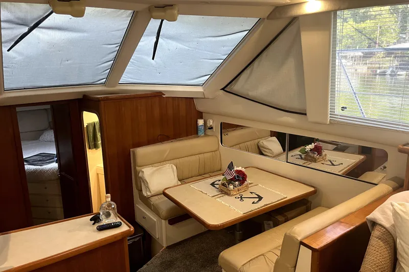 Slide: The Image of Interior of 1998 Carver 355 Aft Cabin yacht with dining area and cozy seating. - 36