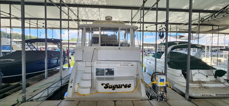 Slide: The Image of 1998 Carver 355 Aft Cabin Motor Yacht docked in marina, rear view. - 5