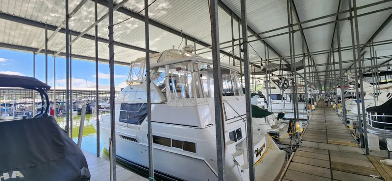 Slide: The Image of 1998 Carver 355 Aft Cabin Motor Yacht docked in a covered marina. - 6