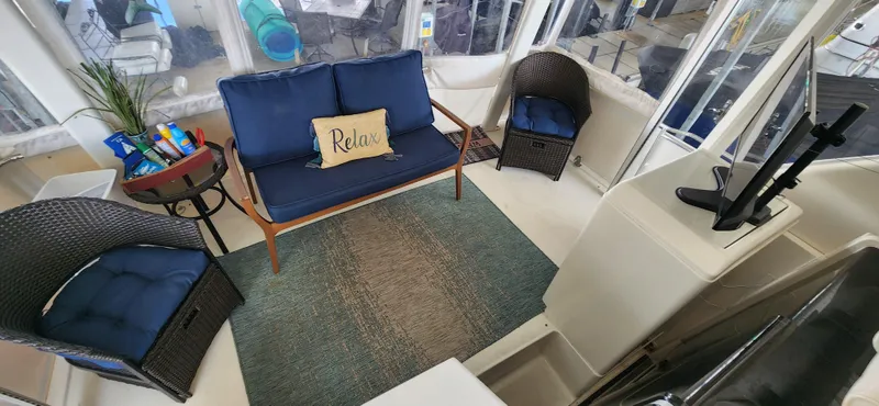 Slide: The Image of 1998 Carver 355 Aft Cabin Motor Yacht interior with cozy seating and "Relax" pillow. - 9