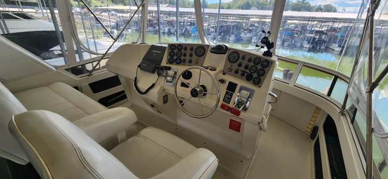Slide: The Image of 1998 Carver 355 Aft Cabin Motor Yacht helm with dual seats and control panel. - 10