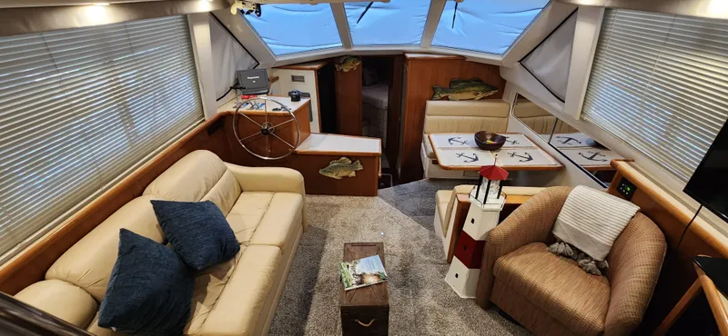 Slide: The Image of Interior of 1998 Carver 355 Aft Cabin Motor Yacht with cozy seating and nautical decor. - 14