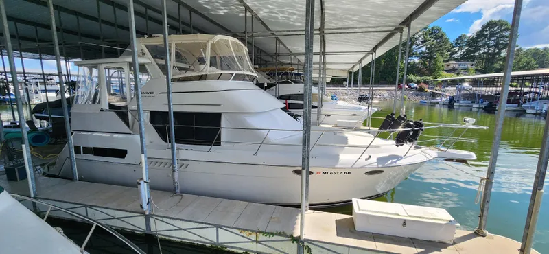 Slide: The Image of 1998 Carver 355 Aft Cabin Motor Yacht docked under a covered marina. - 2