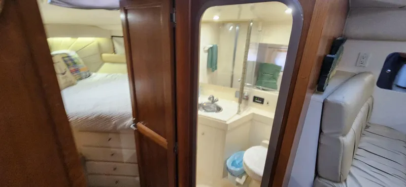 Slide: The Image of 1998 Carver 355 Aft Cabin Motor Yacht interior with bedroom and bathroom view. - 21
