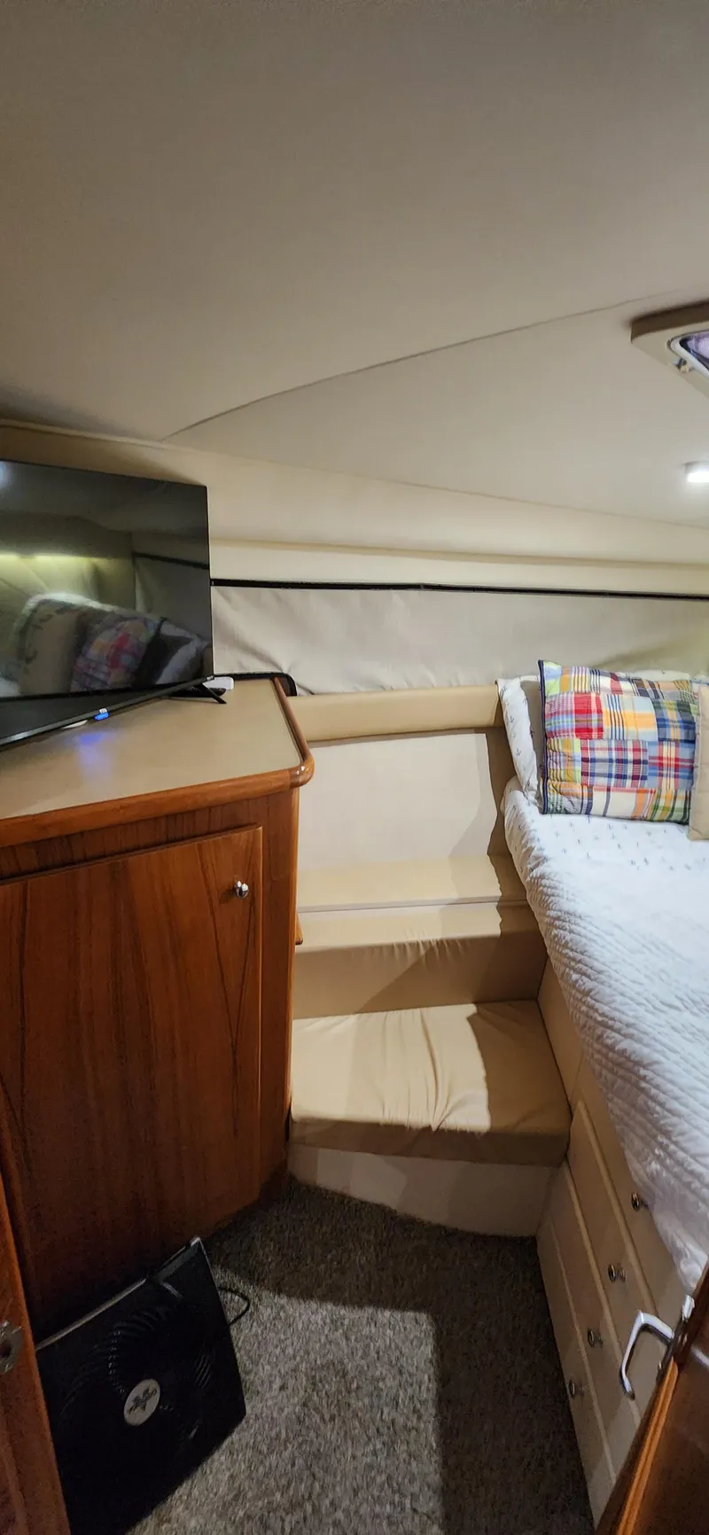 Slide: The Image of 1998 Carver 355 Aft Cabin Motor Yacht interior with bed, TV, and wooden cabinetry. - 23