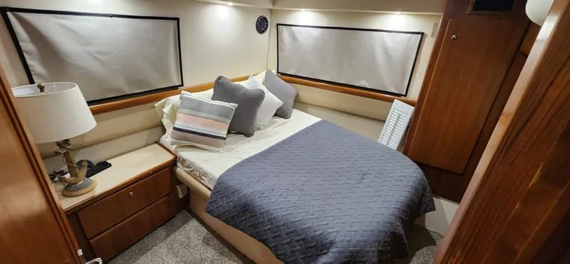 Slide: The Image of 1998 Carver 355 Aft Cabin Motor Yacht bedroom with cozy bed and elegant decor. - 25