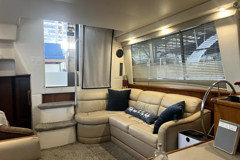 Slide: The Image of 1998 Carver 355 Aft Cabin interior with beige leather seating and modern decor. - 30