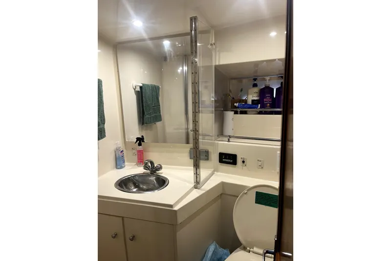 Slide: The Image of Bathroom interior of 1998 Carver 355 Aft Cabin yacht, featuring sink and toiletries. - 31