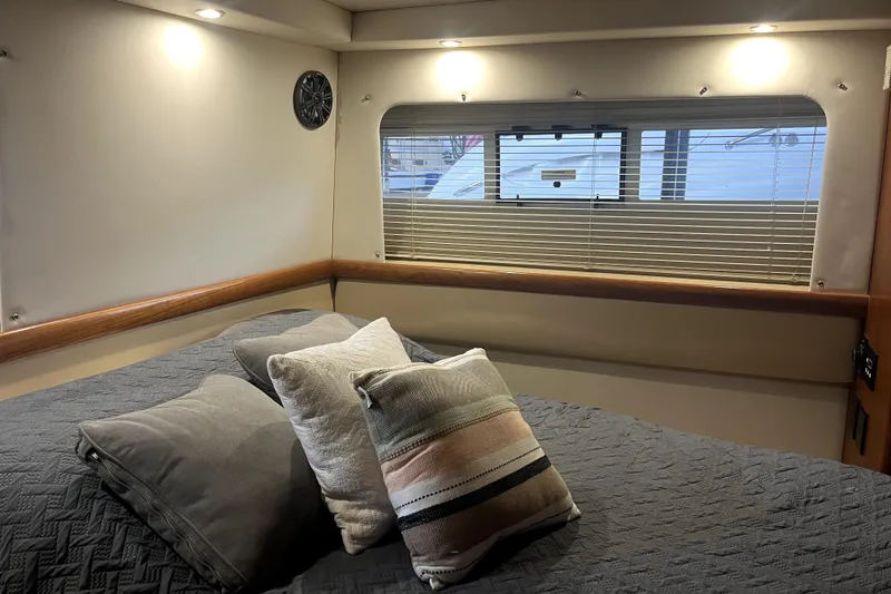 Slide: The Image of Cozy interior of 1998 Carver 355 Aft Cabin with bed and window view. - 33